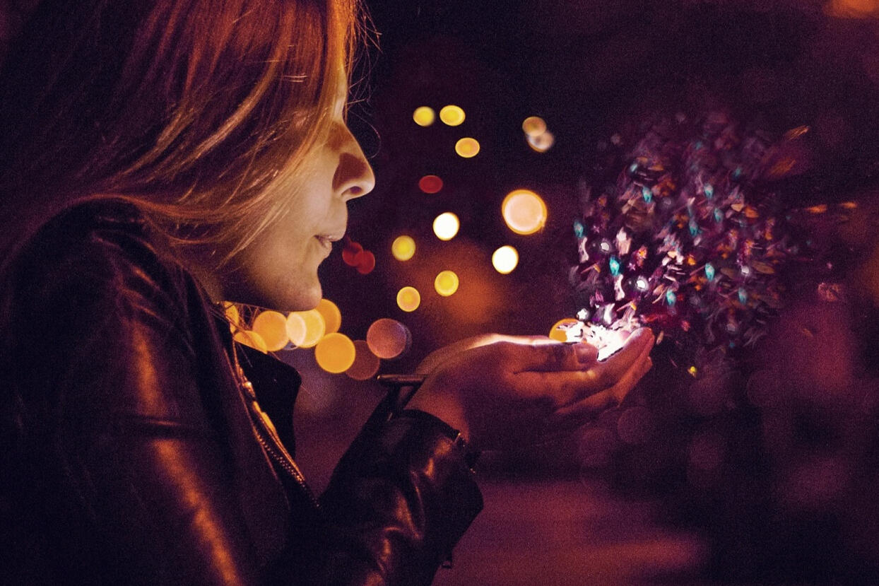 Women holding and blowing on some sparkling lights